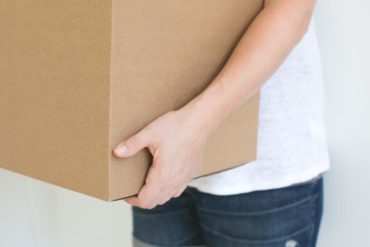 person holding box